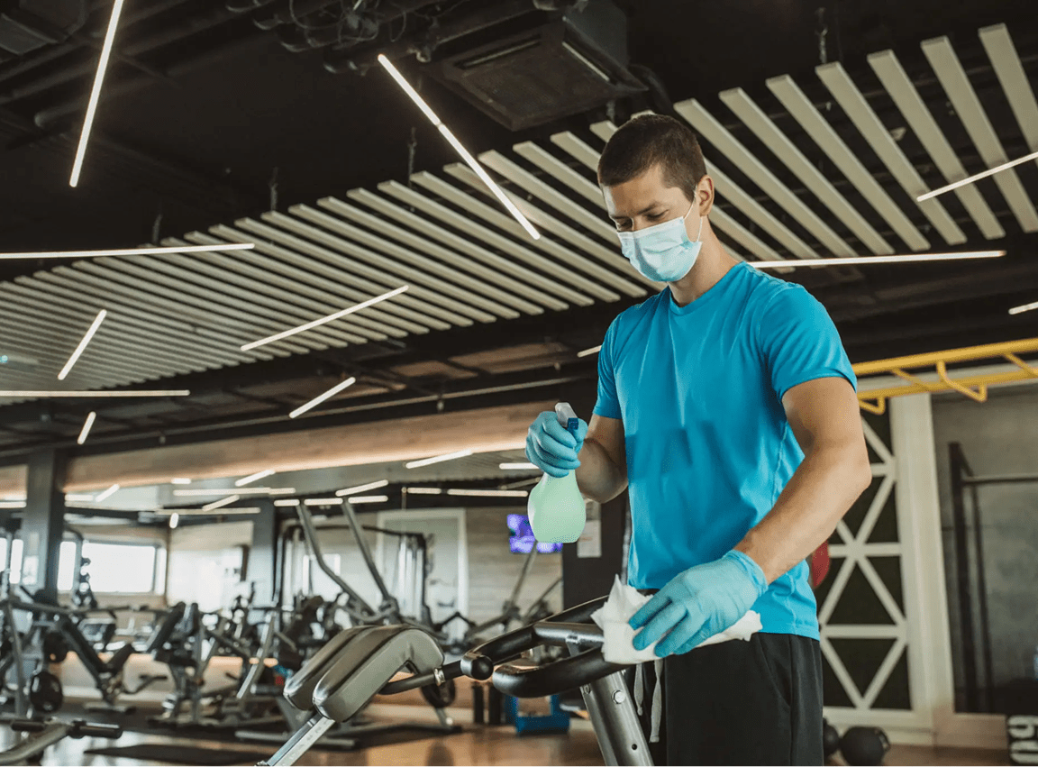Disinfecting exercise machine in gym