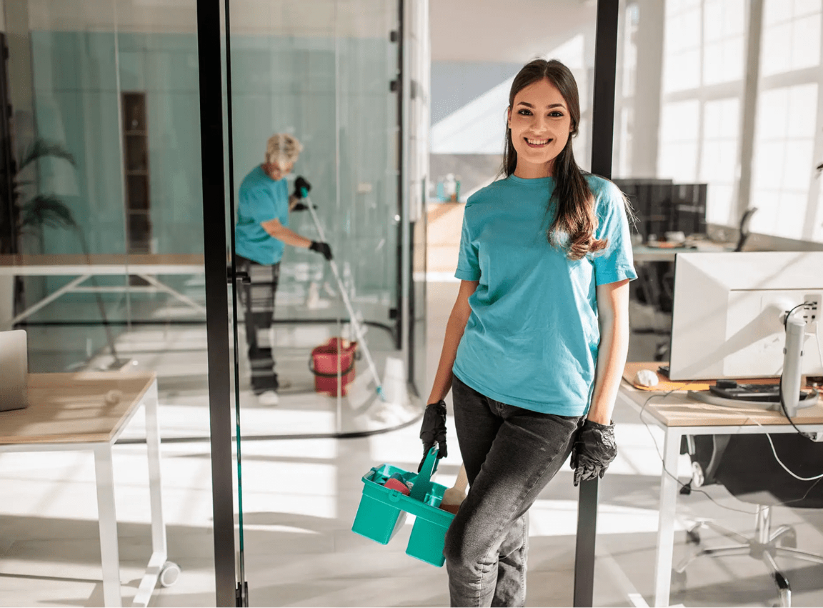 Woman holding cleaning supplies